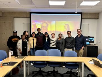 Photo of 13 students in a classroom smiling