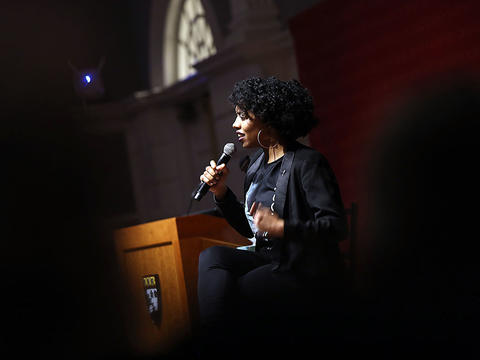 Double take female speaker with microphone